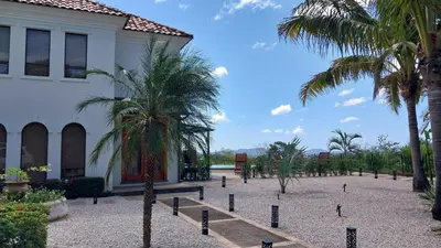 a courtyard with palm trees in front of a building at Villa Estrellas - Stunning Ocean-Views, Potrero, spacious 4 BR Villa in Potrero