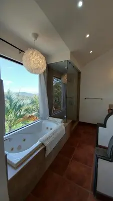 a large bathroom with a tub and a large window at Villa Estrellas - Stunning Ocean-Views, Potrero, spacious 4 BR Villa in Potrero