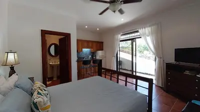 a living room with a bed and a ceiling fan at Villa Estrellas - Stunning Ocean-Views, Potrero, spacious 4 BR Villa in Potrero