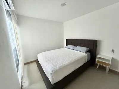 a bedroom with a bed in a white room at 0905 Viva Jaco in Jacó