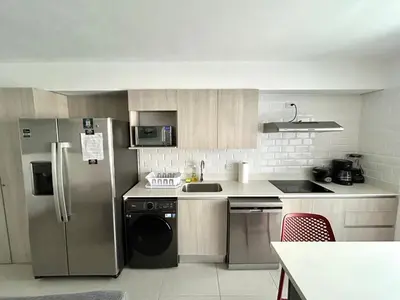 a kitchen with a stainless steel refrigerator and a dishwasher at 0905 Viva Jaco in Jacó