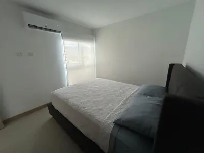 a small bedroom with a bed and a window at 0905 Viva Jaco in Jacó