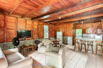 a living room with a couch and chairs and a kitchen at Gamboa Cabin - Delightful Couples Vacation Cabin in Fortuna