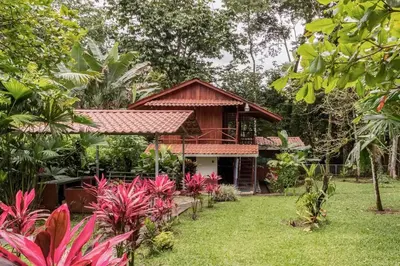 a house in the middle of a garden at Gamboa Cabin - Delightful Couples Vacation Cabin in Fortuna