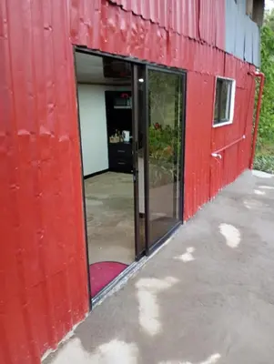 an open door of a red building with a doorway at Marcana Occidente in San Ramón