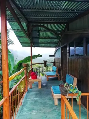 a porch with benches and chairs on a house at Marcana Occidente in San Ramón