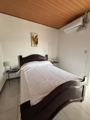 a bedroom with a bed with a wooden ceiling at Depa Koral in Puerto Limón