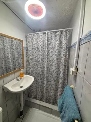 a bathroom with a sink and a shower at Depa Koral in Puerto Limón