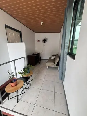 a room with two tables and chairs and a couch at Depa Koral in Puerto Limón