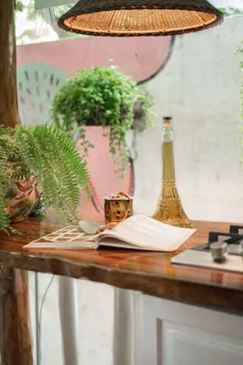 a table with a book and a vase on it at Surf Casitas - Low Tide Bungalow in Santa Teresa Beach