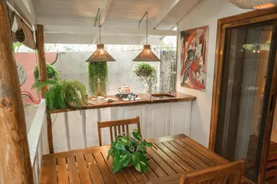 a small kitchen with a table and a counter at Surf Casitas - Low Tide Bungalow in Santa Teresa Beach