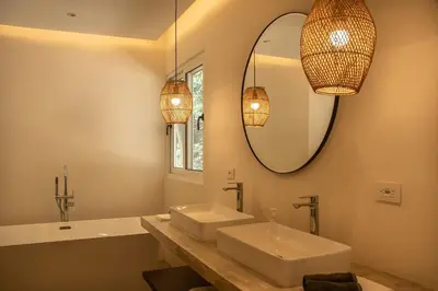a bathroom with a sink and a mirror at Arroyo Tranquilo - Steps to the Beach in Santa Teresa Beach