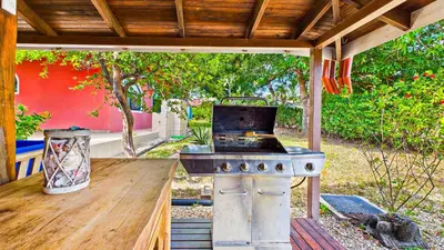 an outdoor kitchen with a stove in a backyard at Casa Colibrí - Villagio 372A in Potrero