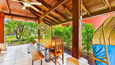 a wooden table and chairs on a patio at Casa Colibrí - Villagio 372A in Potrero