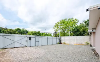 a garage with a white fence and a driveway at Casa Cerca de Tamarindo,ConchalFlamingo,Potrero,Playa Grande,Avellanas,Langosta in Huacas