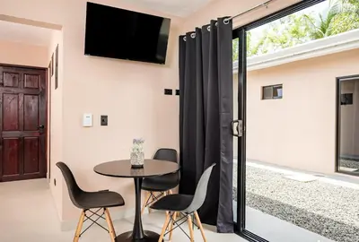 a dining room with a table and chairs and a tv at Casa Cerca de Tamarindo,ConchalFlamingo,Potrero,Playa Grande,Avellanas,Langosta in Huacas