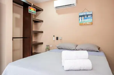 a bedroom with a bed with two towels on it at Casa Cerca de Tamarindo,ConchalFlamingo,Potrero,Playa Grande,Avellanas,Langosta in Huacas