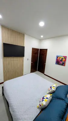 a bedroom with a large bed with two pillows at Los Mangos Nosara in Nosara