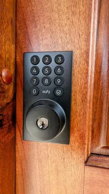 a door with a remote control on a wooden door at Los Mangos Nosara in Nosara