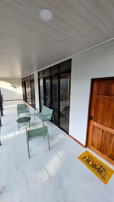 a group of green chairs sitting in a building at Los Mangos Nosara in Nosara