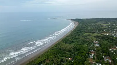 an aerial view of a beach and the ocean at ROQUI Cozy Beachfront Cabin in Uvita