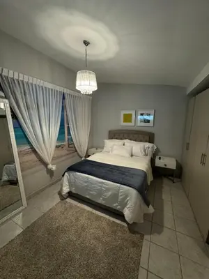 a bedroom with a large bed and a window at Casa Arte Jaco in Jacó