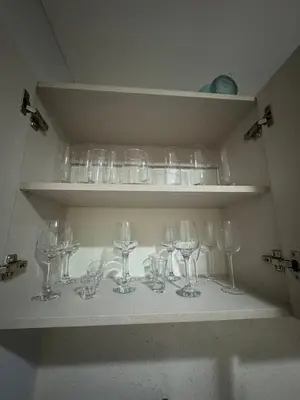 a bunch of wine glasses sitting on a shelf at Casa Arte Jaco in Jacó