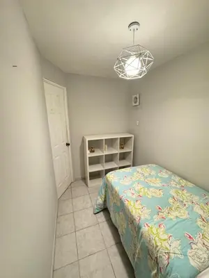 a bedroom with a bed and a light at Casa Arte Jaco in Jacó