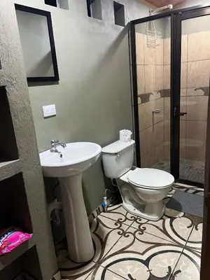 a bathroom with a toilet and a sink at Apartamento Lulú in Uvita