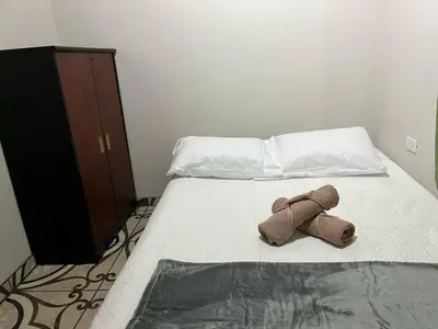 a brown teddy bear laying on a bed at Apartamento Lulú in Uvita
