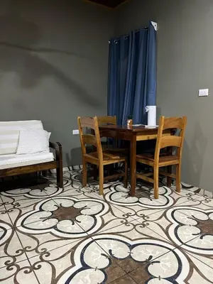 a dining room with a table and chairs and a bed at Apartamento Lulú in Uvita