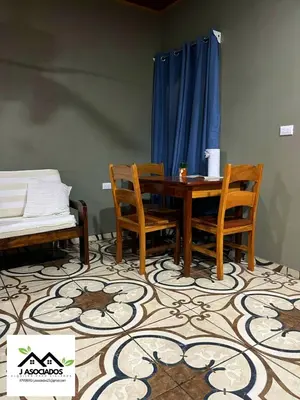a dining room with a table and two chairs at Apartamento Lulú in Uvita