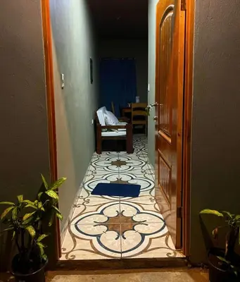 a hallway with a tile floor and a room with a door at Apartamento Lulú in Uvita