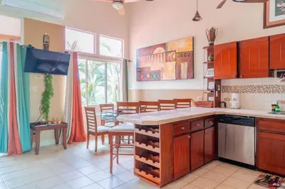 a kitchen with a table and a dining room at Altavista #3 in Jacó
