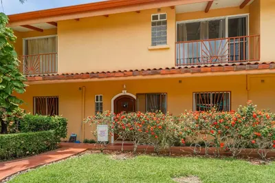 a house with flowers in front of it at Altavista #3 in Jacó
