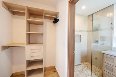 a bathroom with a walk in shower next to a glass door at Luxury Oceanview Penthouse, Breathtaking Sunsets in Tamarindo
