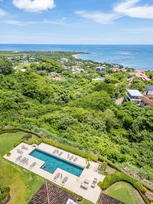 an overhead view of a swimming pool and the ocean at Luxury Oceanview Penthouse, Breathtaking Sunsets in Tamarindo