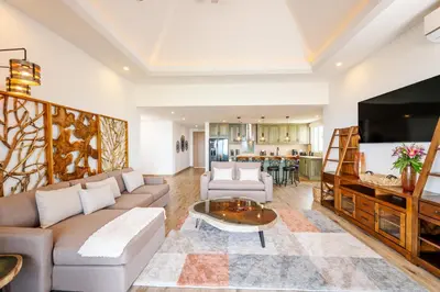a living room with a couch and a tv at Luxury Oceanview Penthouse, Breathtaking Sunsets in Tamarindo