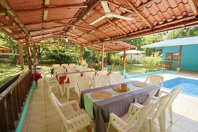 a patio with a table and chairs and a pool at Camping Finca Planeta Sano in Naranjito