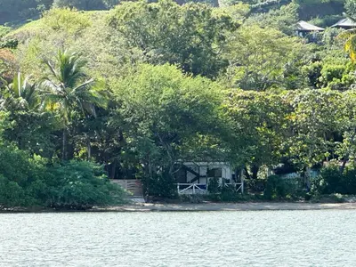 a house on the shore of a body of water at La Chozita in Tamarindo