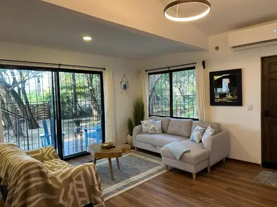 a living room with a couch and a table at La Chozita in Tamarindo