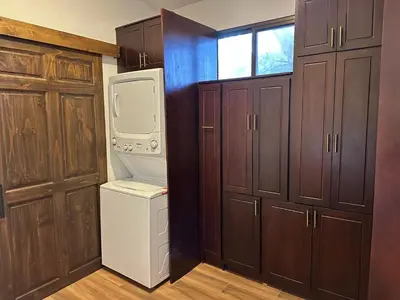 a kitchen with a refrigerator and a washer and dryer at La Chozita in Tamarindo