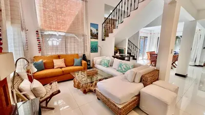 a living room with a couch and a table at La Flor beach Condos in Jacó