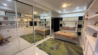 a bedroom with a bed and a glass wall at La Flor beach Condos in Jacó
