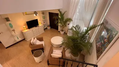 an aerial view of a living room with a television at La Flor beach Condos in Jacó