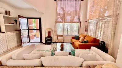 a living room with two white couches in a room at La Flor beach Condos in Jacó