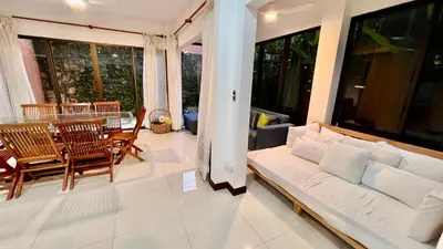a living room with a white couch and a table at La Flor beach Condos in Jacó