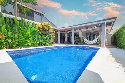 a swimming pool in the backyard of a house at Villa Atardecer by Vacation Pura Vida in Bejuco