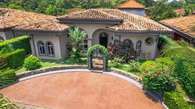 a house with a brick driveway in front of it at Villa Atardecer by Vacation Pura Vida in Bejuco