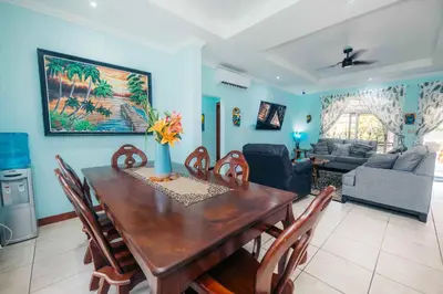 a living room with a wooden table and chairs at Villa Atardecer by Vacation Pura Vida in Bejuco